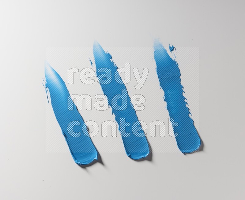 Blue painting knife strokes on white background