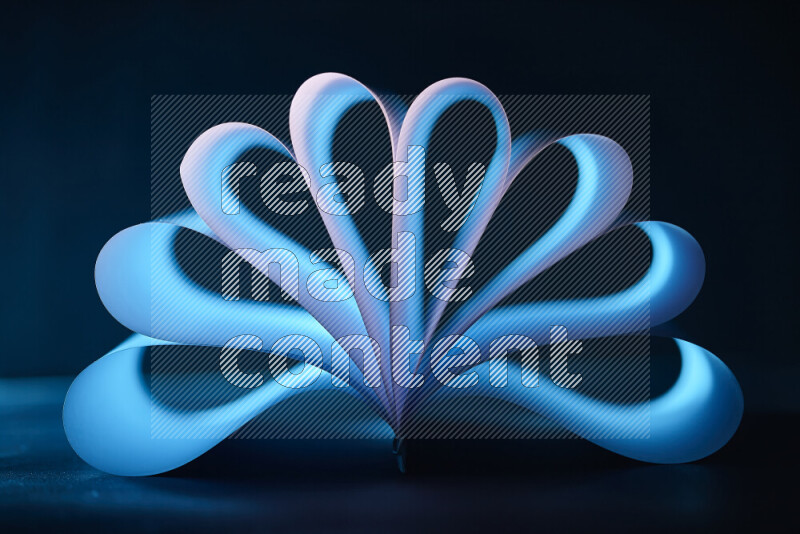 An abstract art piece displaying smooth curves in blue gradients created by colored light