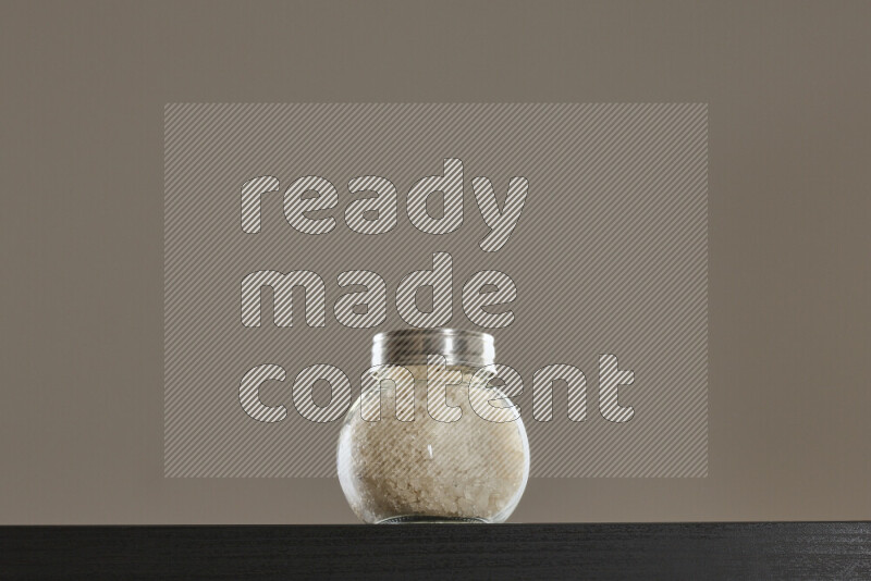 Salt in a glass jar on black background