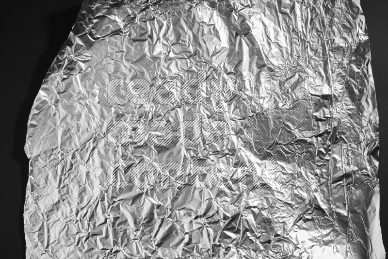 Aluminium foil on black background