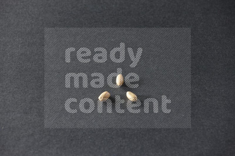 3 peeled peanuts on a black background in different angles
