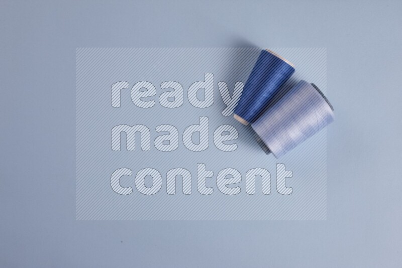 A blue collection of sewing and tailoring tools arranged on a blue background