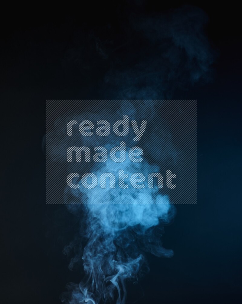 Heavy smoke in blue isolated on black background