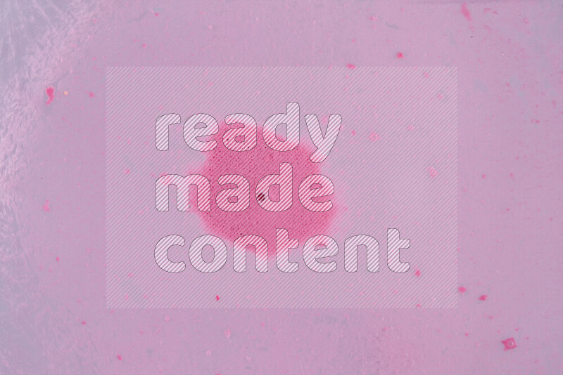 The image captures a dramatic splatter of pink paint over a white backdrop