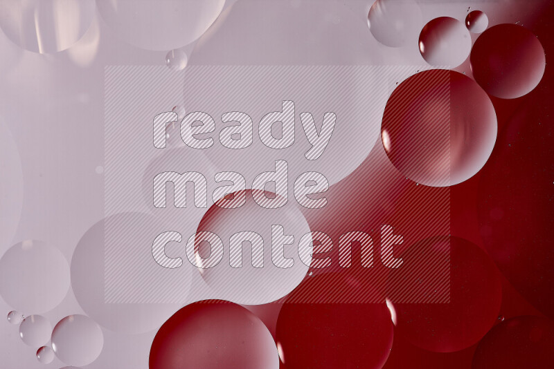 Close-ups of abstract oil bubbles on water surface in shades of white and red