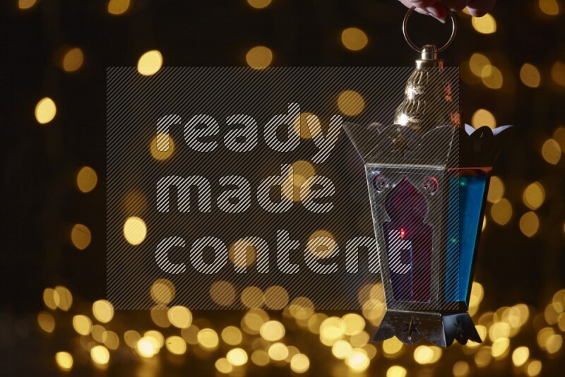A traditional ramadan lantern surrounded by glowing fairy lights in a dark setup