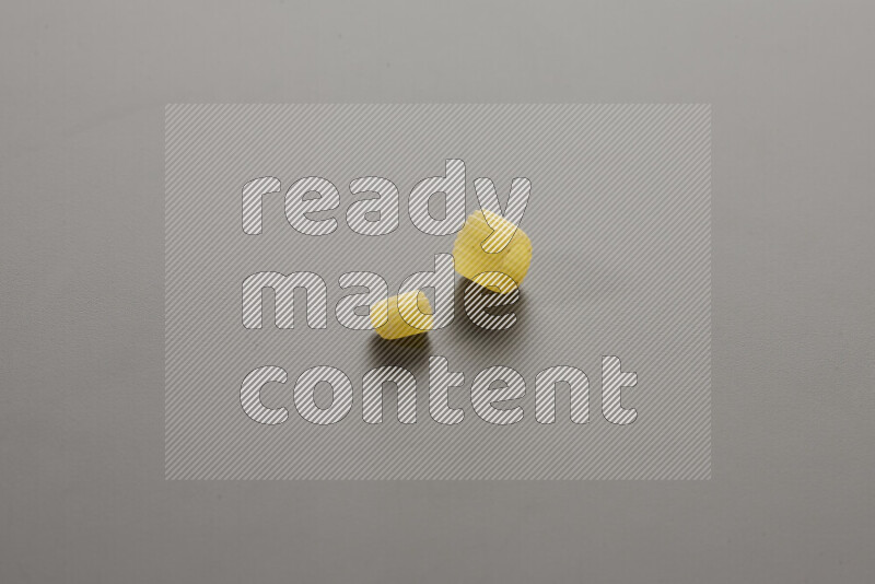 Small rings pasta with other types of pasta on grey background