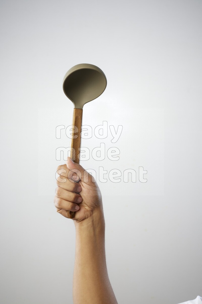 Male Hand Holding ladle on white background