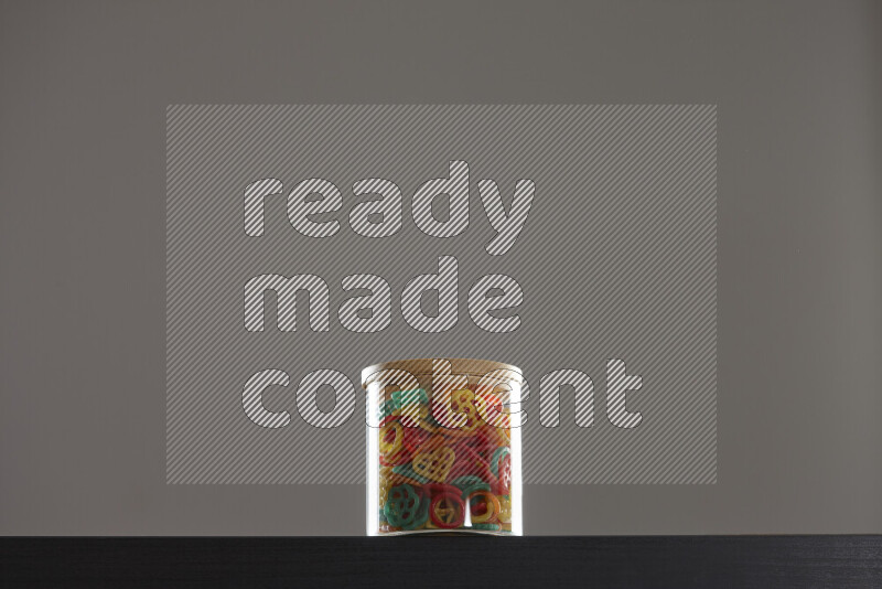 Snacks in a glass jar on black background