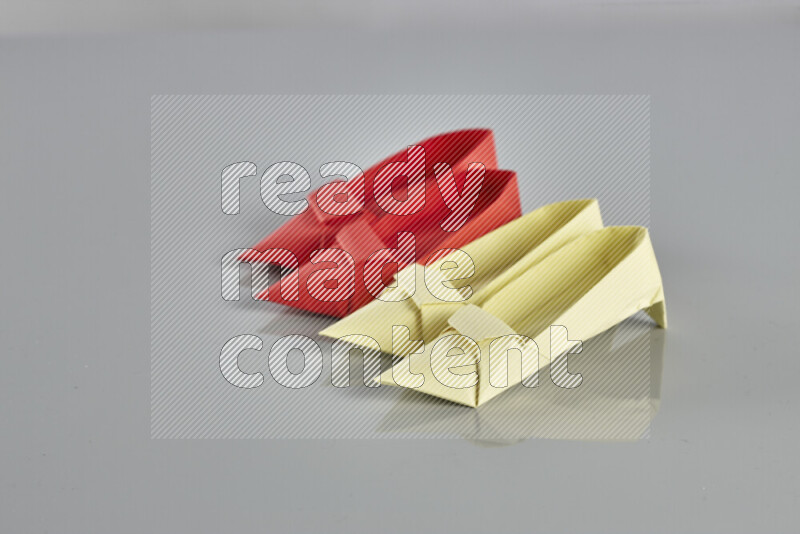 Origami shoes on grey background