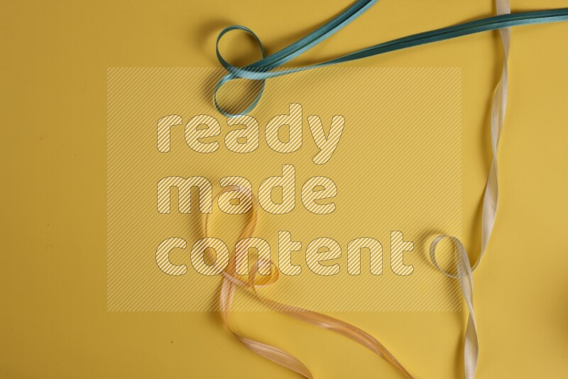 A green collection of sewing and tailoring tools arranged on a yellow background