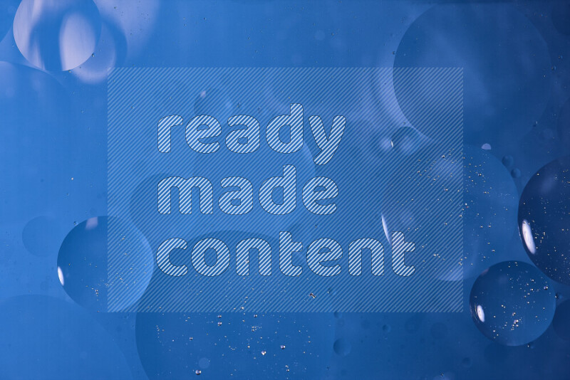 Close-ups of abstract oil bubbles on water surface in shades of blue