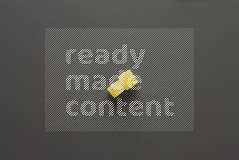 Big rings pasta on grey background