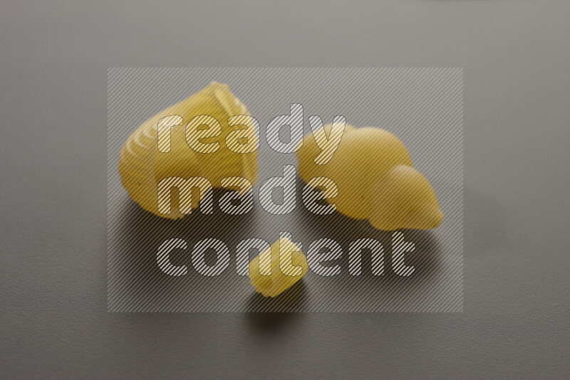 Different pasta types on grey background