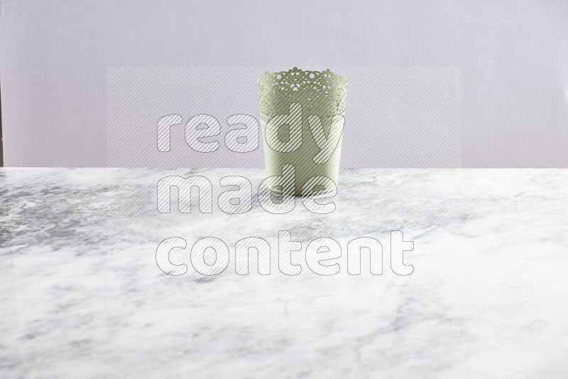 An empty green plant pot on grey marble background
