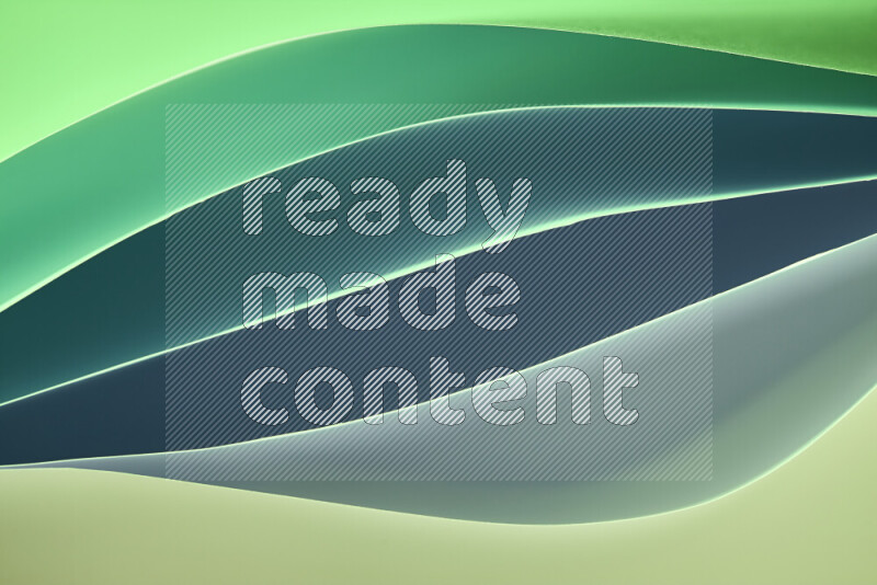 This image showcases an abstract paper art composition with paper curves in green gradients created by colored light