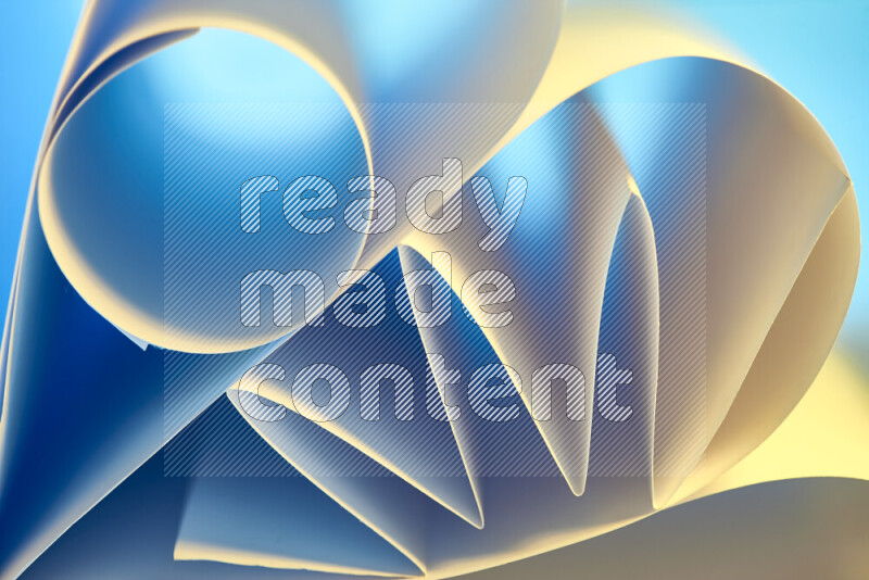 An artistic display of paper folds creating a harmonious blend of geometric shapes, highlighted by soft lighting in blue and warm tones