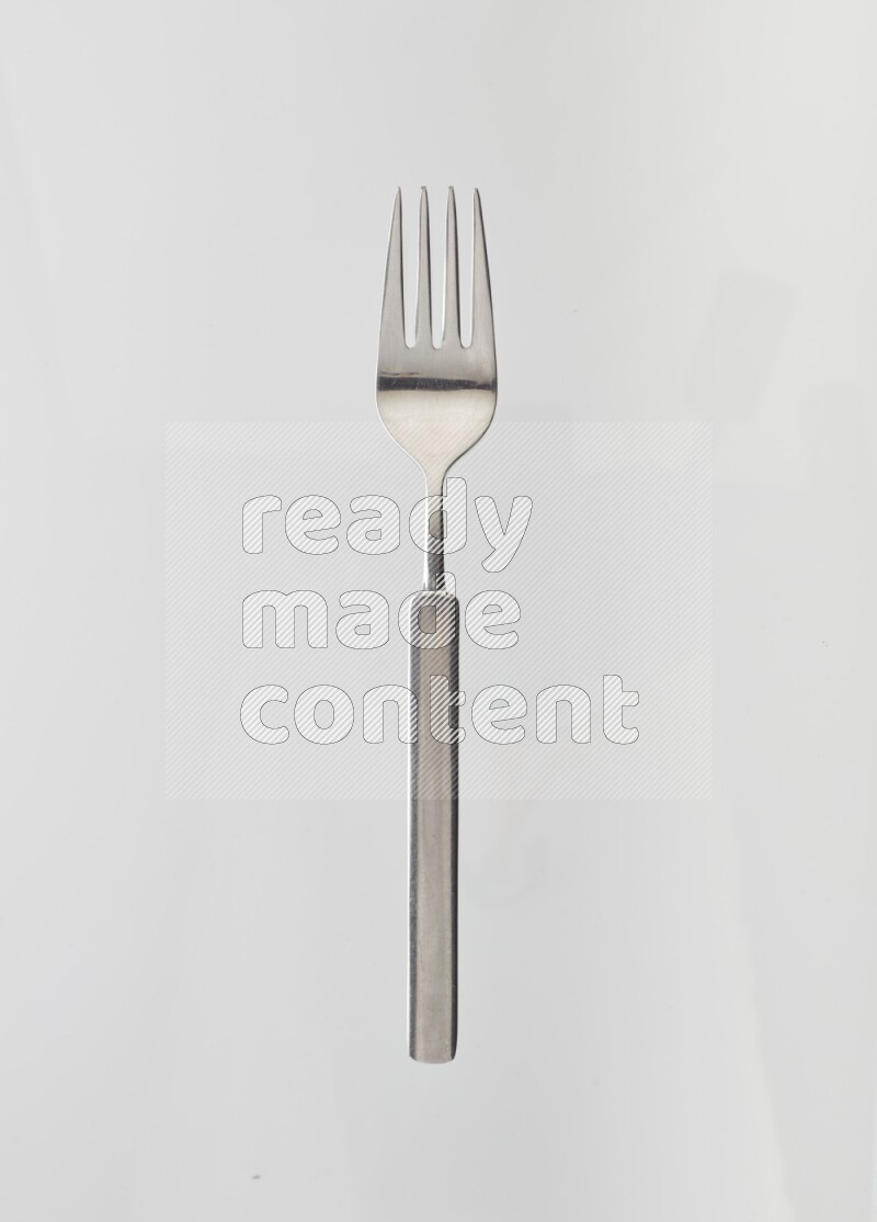Silver stainless steel fork on white background