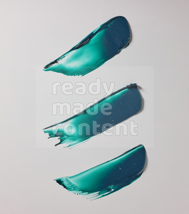 Turquoise painting knife strokes on white background