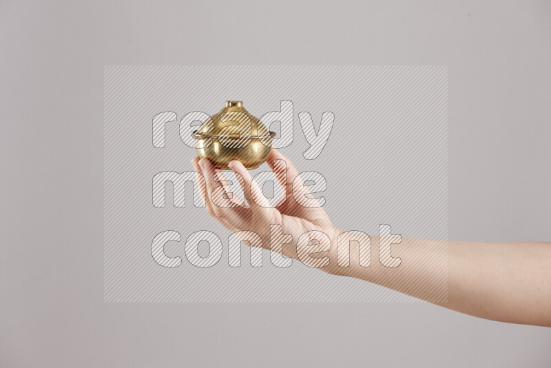 Woman hands holding different metal essentials in different positions