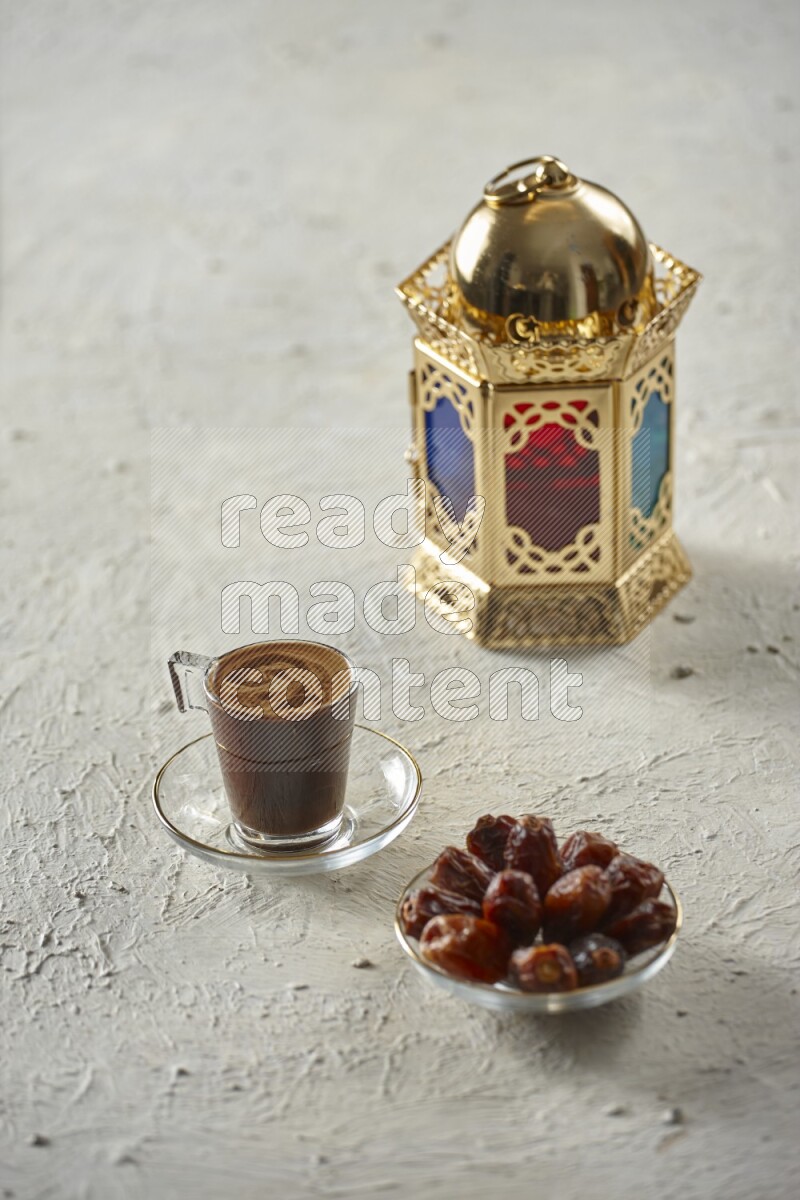 A golden lantern with different drinks, dates, nuts, prayer beads and quran on textured white background
