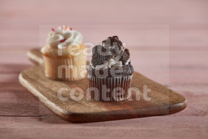 Chocolate mini cupcake topped with oreo on a wooden board