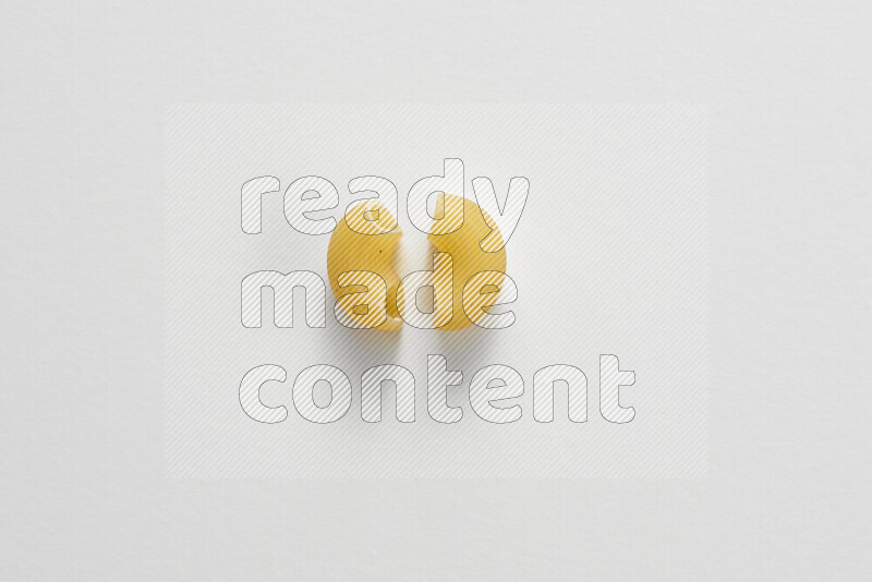 Elbow pasta on white background