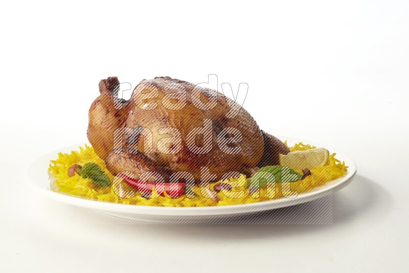 yellow  basmati Rice with  whole roasted chicken on a white rounded plate direct on white background