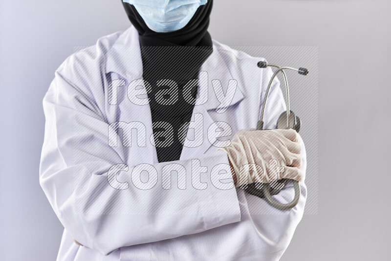 Female doctor wearing an abaya and medical attire in different positions