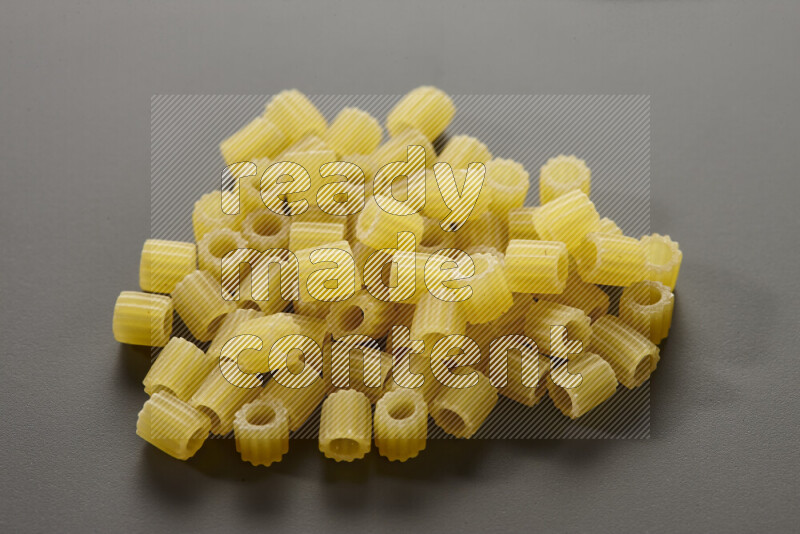Small rings pasta on grey background