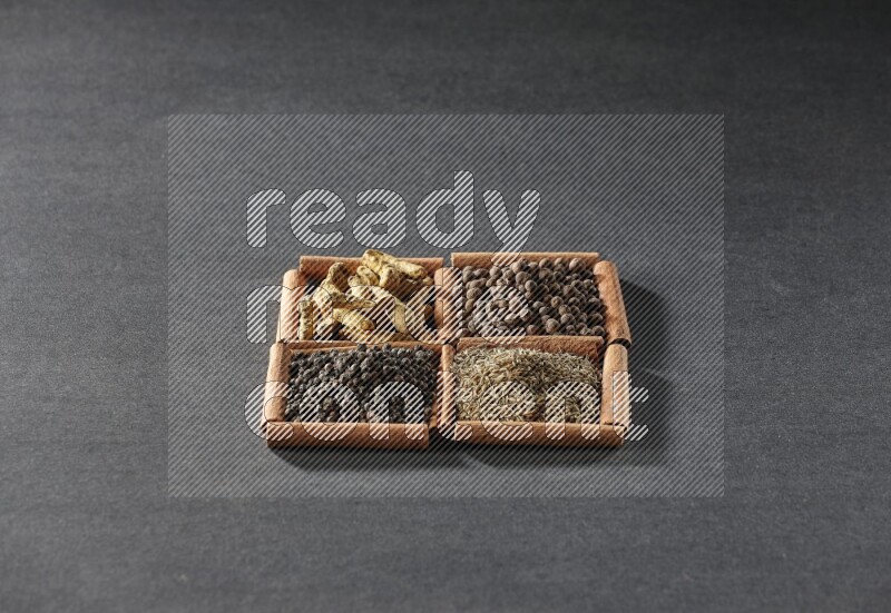 4 squares of cinnamon sticks full of black pepper, cumin, allspice and turmeric fingers on black flooring