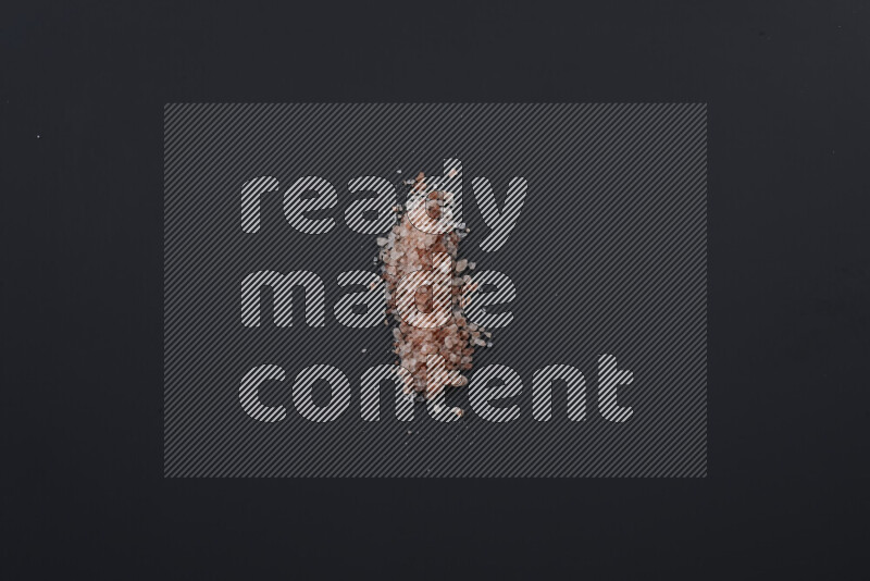 Bunches of table salt, coarse sea salt, fine himalayan salt and coarse himalayan salt on black background