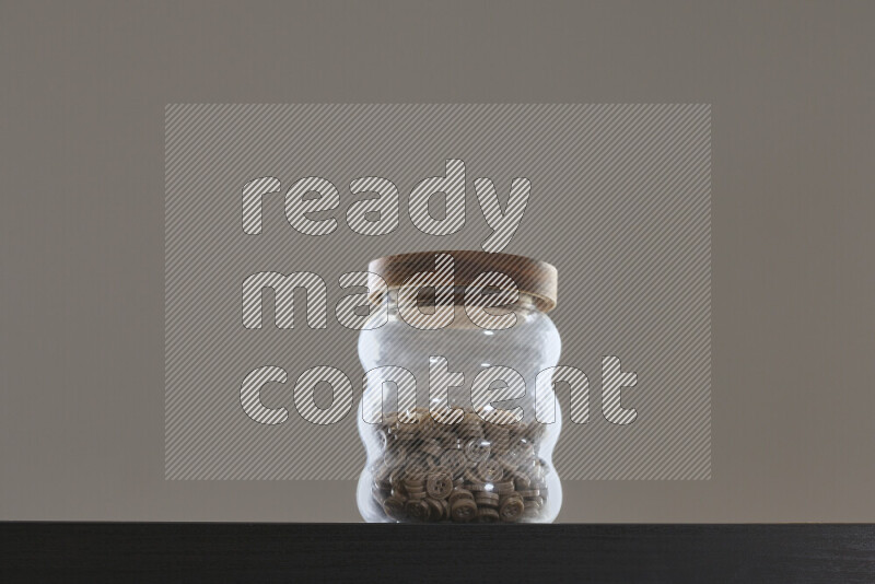 Buttons in a glass jar on black background