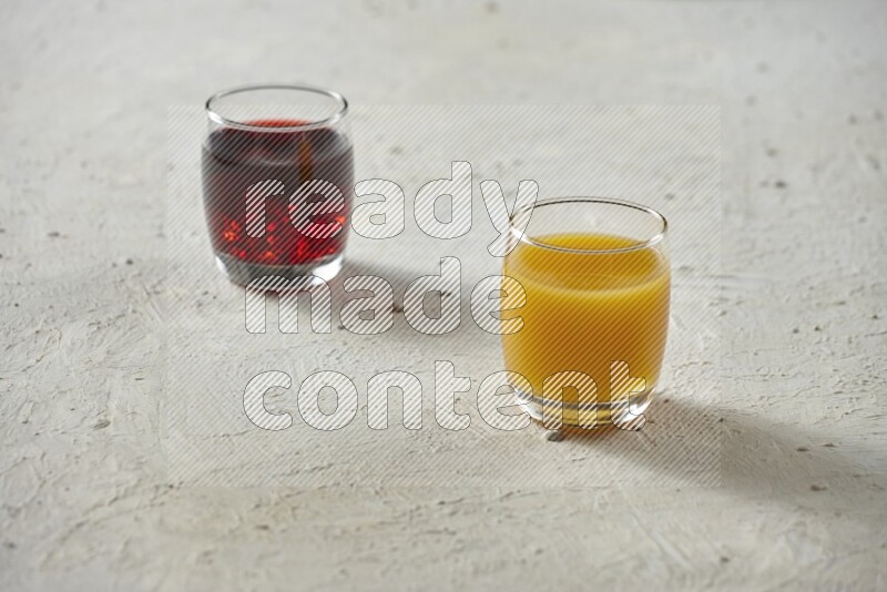 Cold drinks in a glass cup such as water, tamarind, qamar eldin, sobia, milk and hibiscus on textured white background