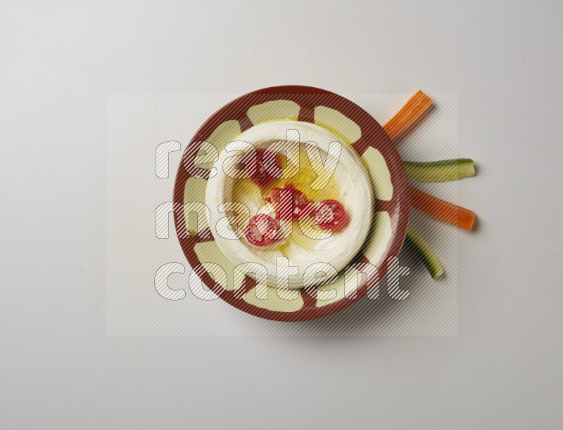 Lebnah garnished with Cherry tomato in a traditional plate on a white background