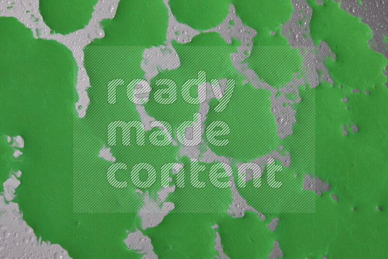Close-ups of abstract green paint droplets on the surface