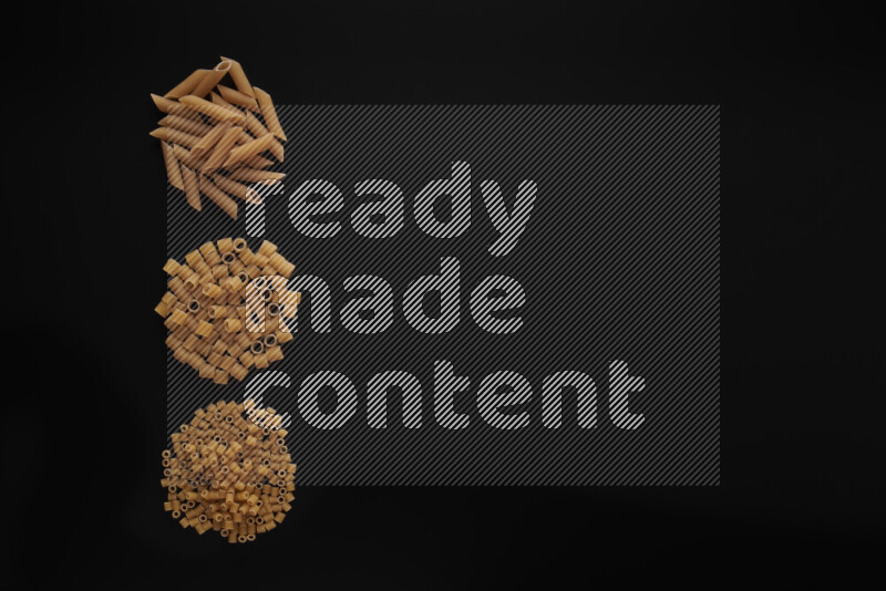 Different pasta types in 3 bunches on black background