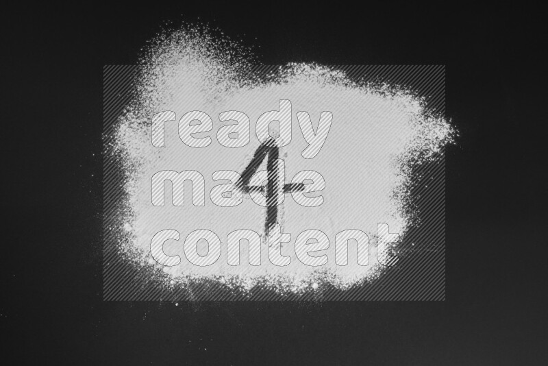 Numbers written with powder on black background