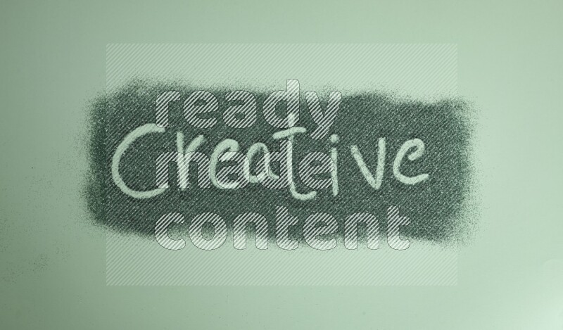 A word written with green glitter on green background