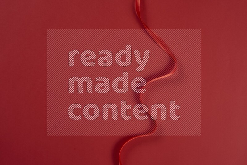 A red collection of sewing and tailoring tools arranged on a red background