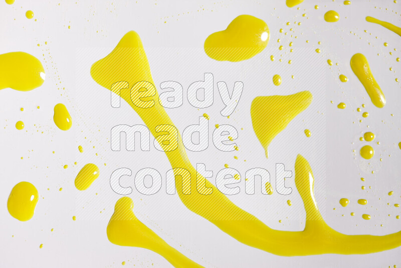 Close-ups of abstract yellow paint droplets on white background