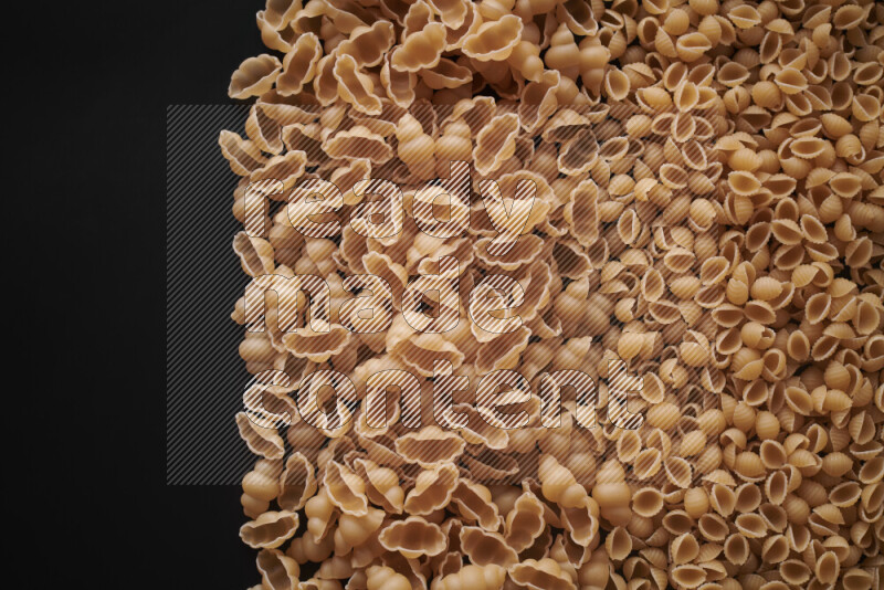 Different pasta types on black background