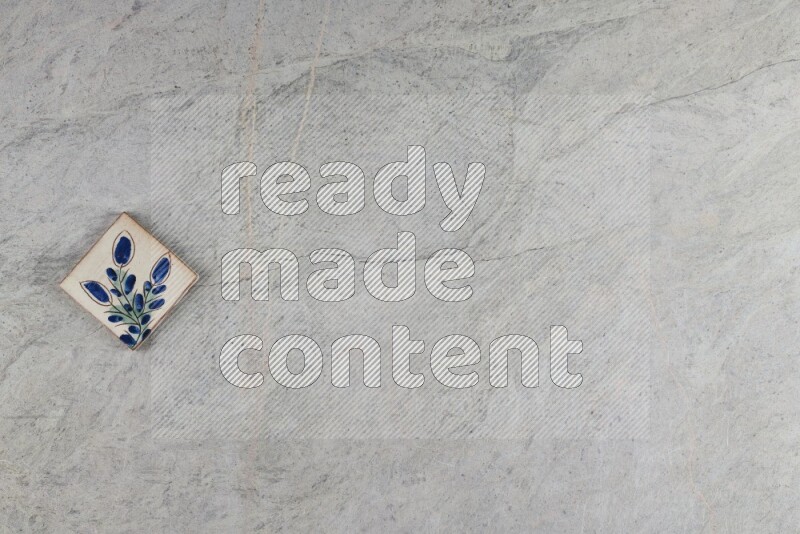 A decorative pottery coaster on grey marble background