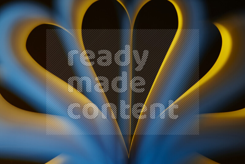 An abstract art piece displaying smooth curves in yellow and blue gradients created by colored light