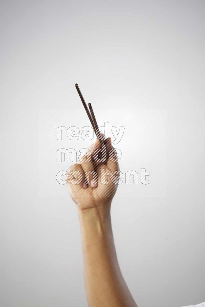Male Hand Holding Chop Stick on white background