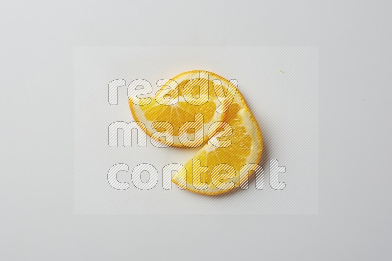 Three halves of an orange slices on white background