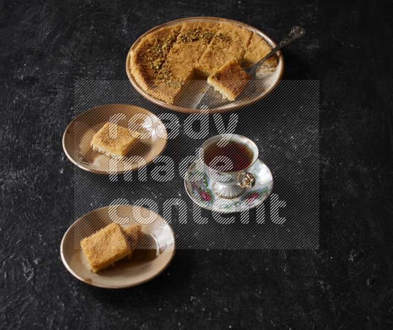 konafa with tea in a dark setup