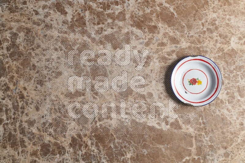 A vintage metal plate on beige marble background