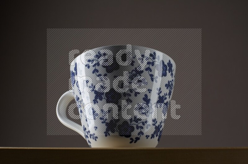 Low angle shot of a decorated cup on grey background