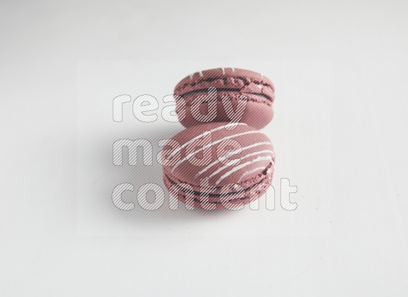 45º Shot of two Red Poppy Flower macarons on white background